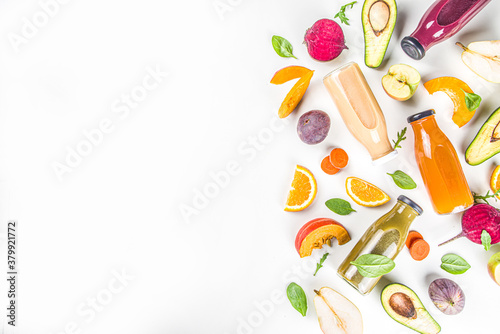 Fruit and vegetable smoothie concept. Portioned bottles with fruit and vegetable smoothies flatlay with fresh ingredients on white table background