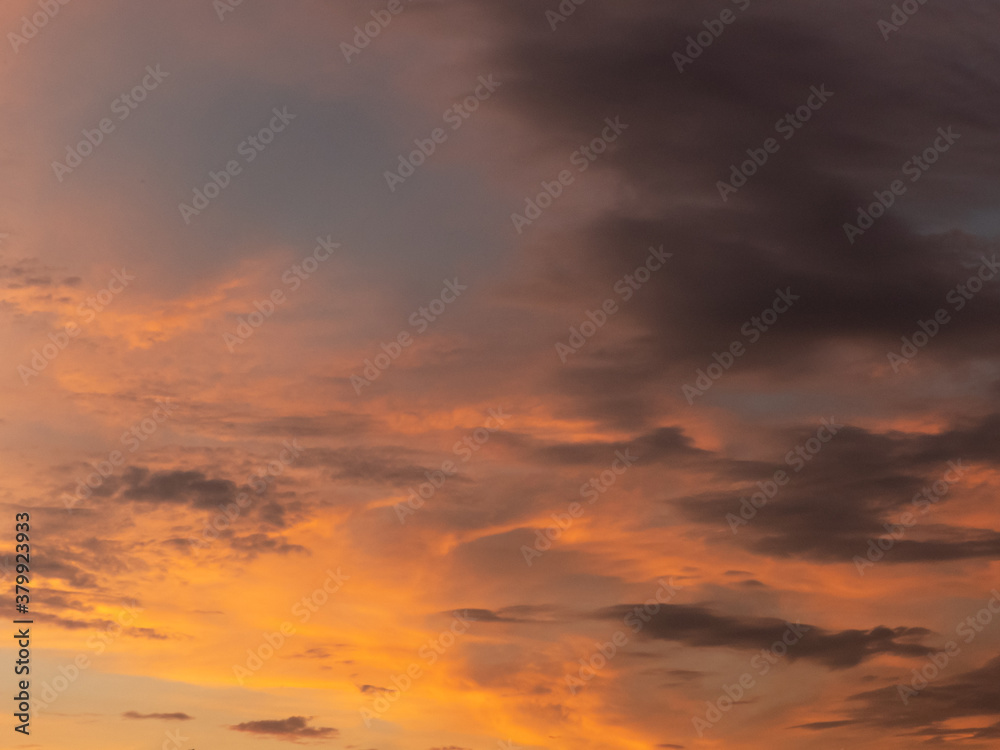sky during sunset, shades of orange and dramatic clouds