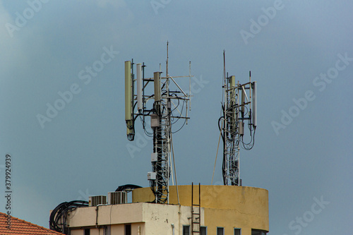 microwave antenna tower on blue sky background