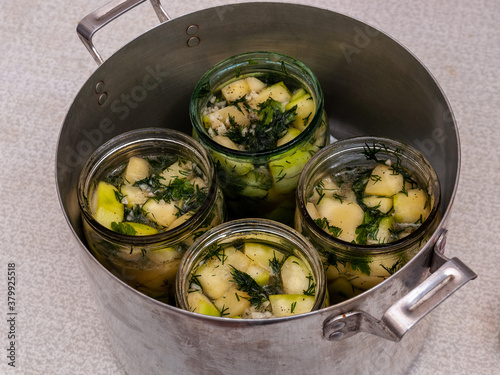 фотографія jars of vegetables in a large aluminum pan