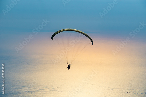 Paraglider flying on Oludeniz beach in Fethiye, Mugla, Travel destination. Summer and holiday concept.