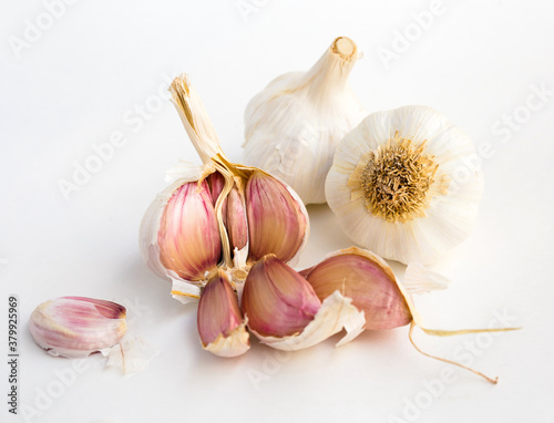 garlic heads and cloves on white background