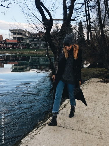 Woman walking by the beautiful river Una in Bihac photo