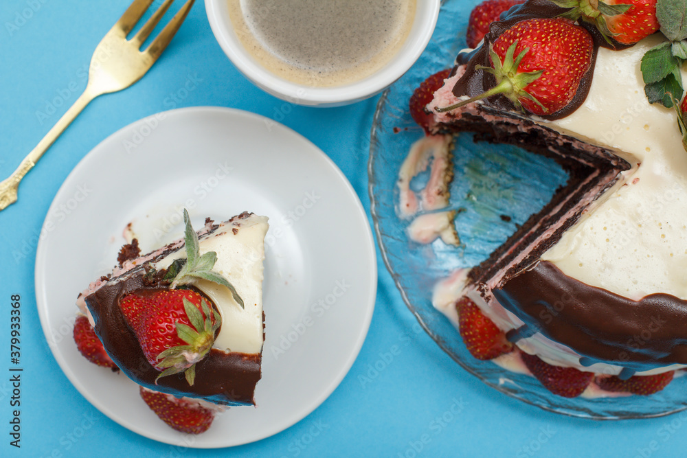Homemade chocolate cake decorated with fresh strawberries and cup of coffee Homemade chocolate cake decorated with fresh strawberries and cup of coffee