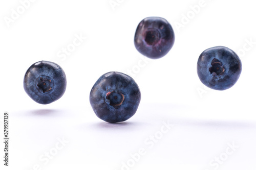 Blueberries jumping on white background. Fresh natural forest fruits closeup.