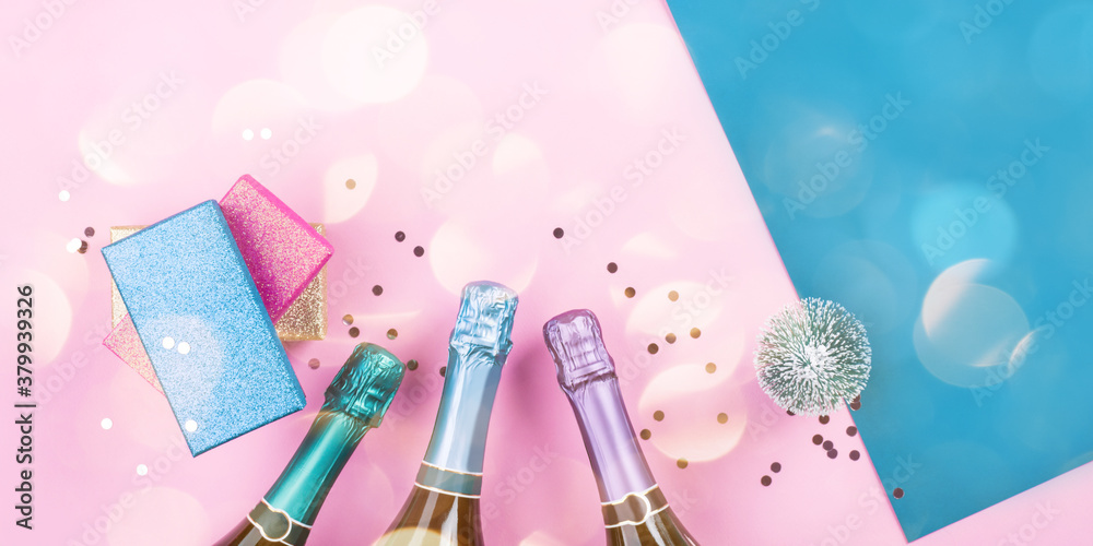 Εκτύπωση καμβά Champagne bottle, gifts and confetti on pink and blue background with sparkling confetti