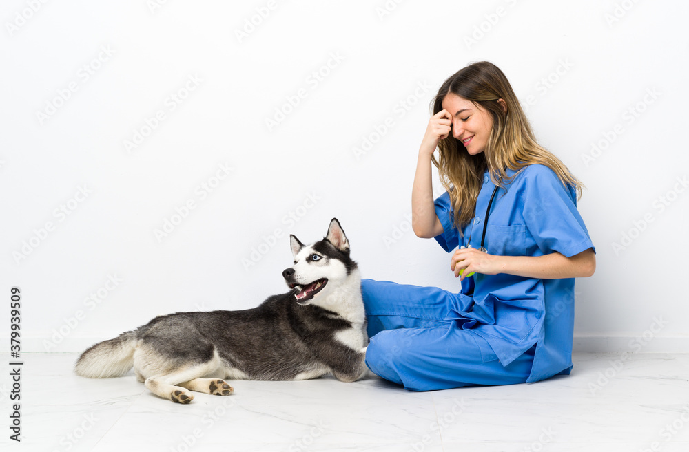Veterinary doctor at vet clinic with Siberian Husky dog
