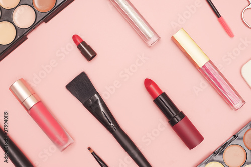 set of professional cosmetics, makeup tools and accessories on pink background, beauty, fashion, shopping concept, flat lay
