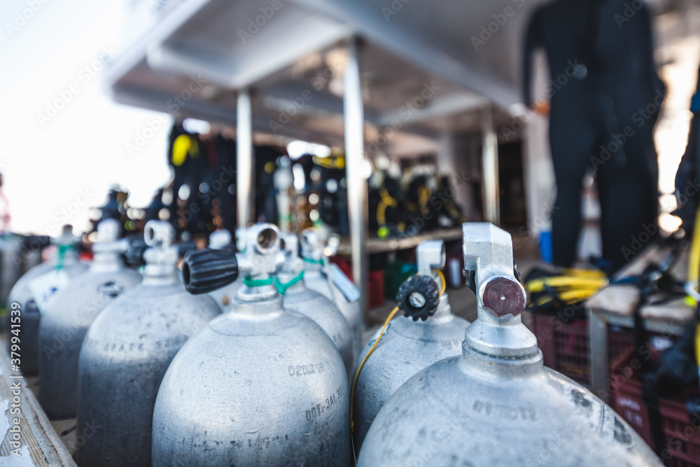 Diving tanks and equipment on a cruise ship with view of the sea Diving tanks and equipment on a cruise ship with view of the sea