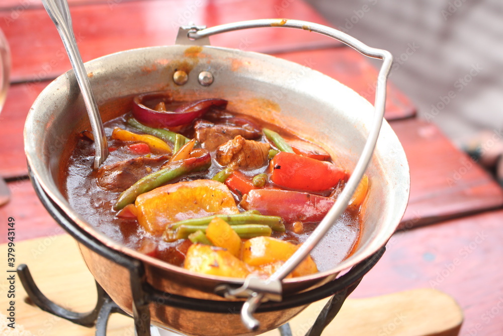 Close up of a bowl of Goulasch, vegetables and meat in soup, Czech Cuisine, Czech Republic, Europe, Soft Focus Close up of a bowl of Goulasch, vegetables and meat in soup, Czech Cuisine, Czech Republic, Europe, Soft Focus