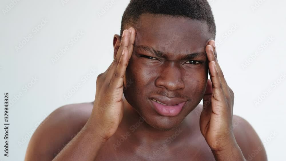 Man grooming. Skin rejuvenation. Portrait of unhappy shirtless black guy touching face dissatisfied isolated on neutral background. Aesthetic cosmetology. Skincare procedure. Man grooming. Skin rejuvenation. Portrait of unhappy shirtless black guy touching face dissatisfied isolated on neutral background. Aesthetic cosmetology. Skincare procedure.