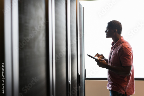 Wallpaper Mural Horizontal view of a technician looking into a server room cabin Torontodigital.ca