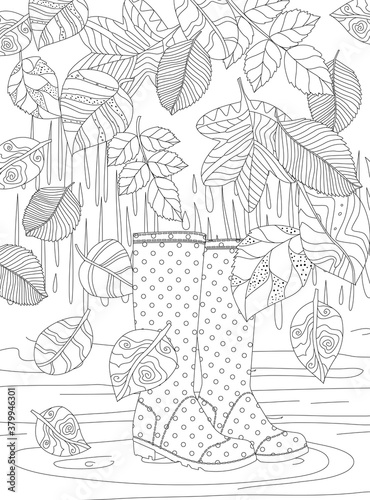 falling autumn bizarre leaves on polka dot rubber boots standing