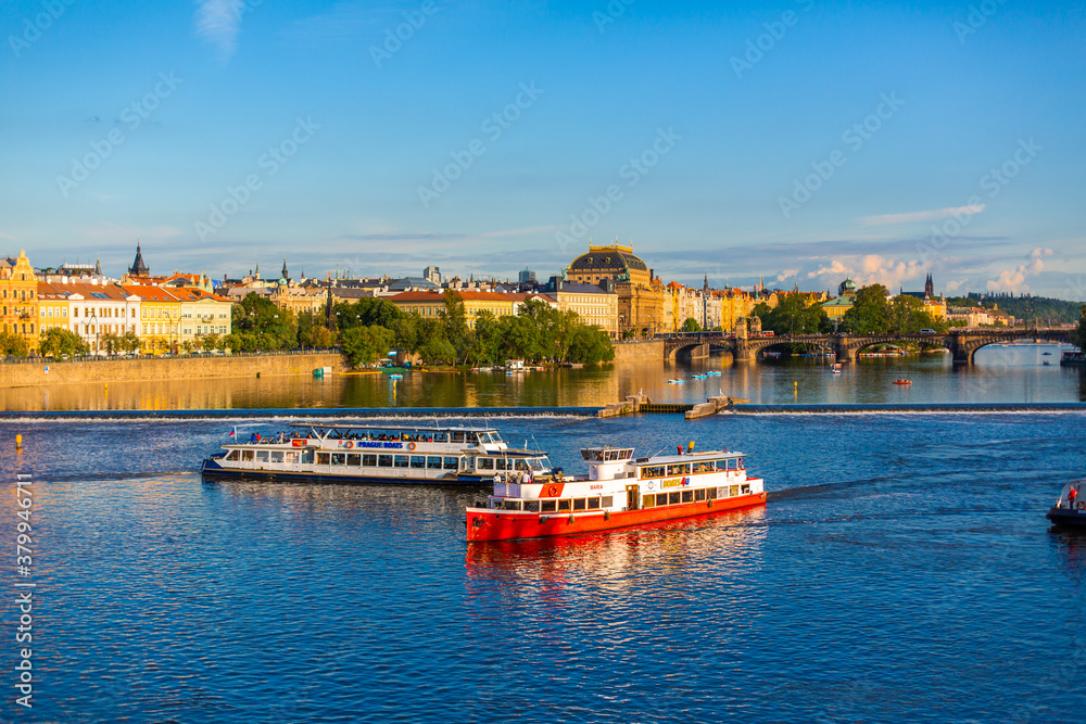Summer landscape of Prague view of the Ltava river on which ferries with tourists float Summer landscape of Prague view of the Ltava river on which ferries with tourists float