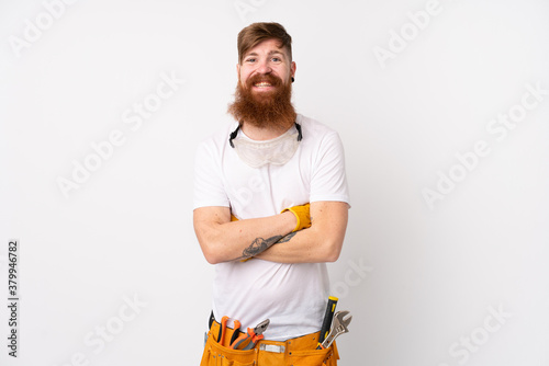 Redhead electrician man with long beard over isolated white background laughing