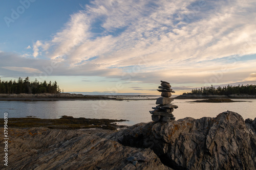 View of an Inukshuk on a rocky beach in the Bic national park, Canada