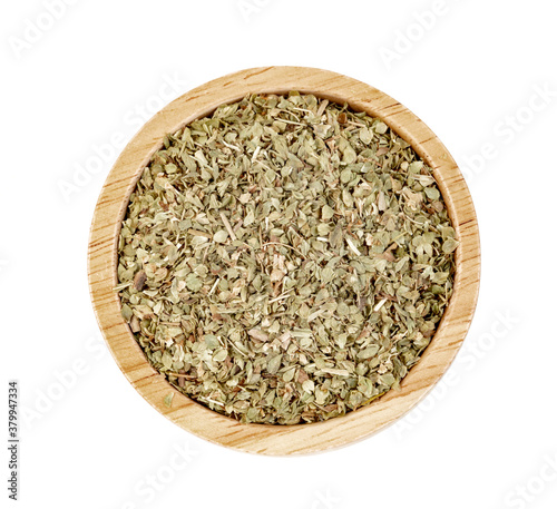 Oregano in wooden bowl isolated on white background