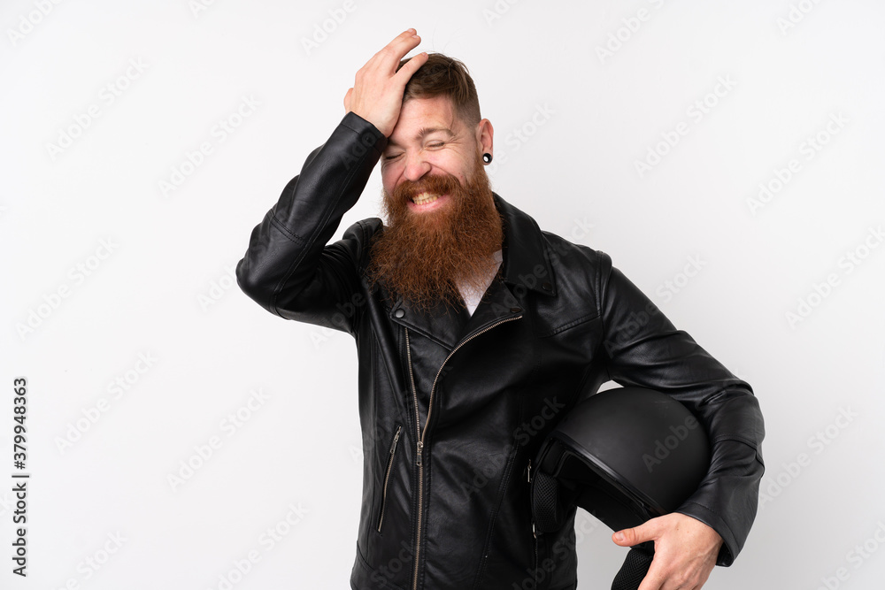 Naklejka premium Redhead man with long beard holding a motorcycle helmet over isolated white background having doubts with confuse face expression