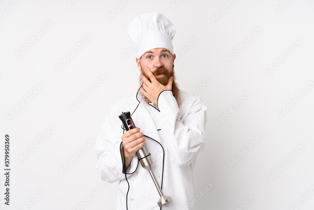 Redhead man using hand blender over isolated white background thinking an idea Redhead man using hand blender over isolated white background thinking an idea