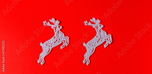 Figure of a Christmas decoration on a red solid background.