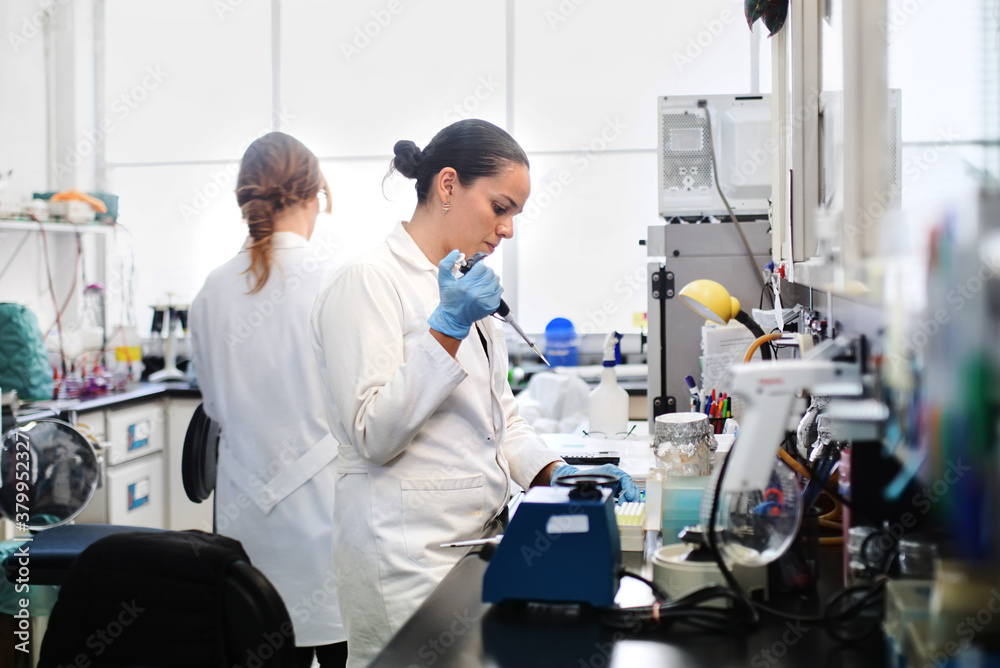 Female researcher working on DNA project Female researcher working on DNA project