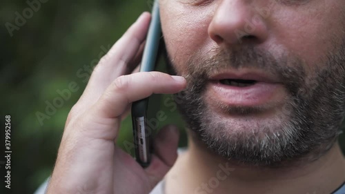 man talking on the phone for a walk, close up