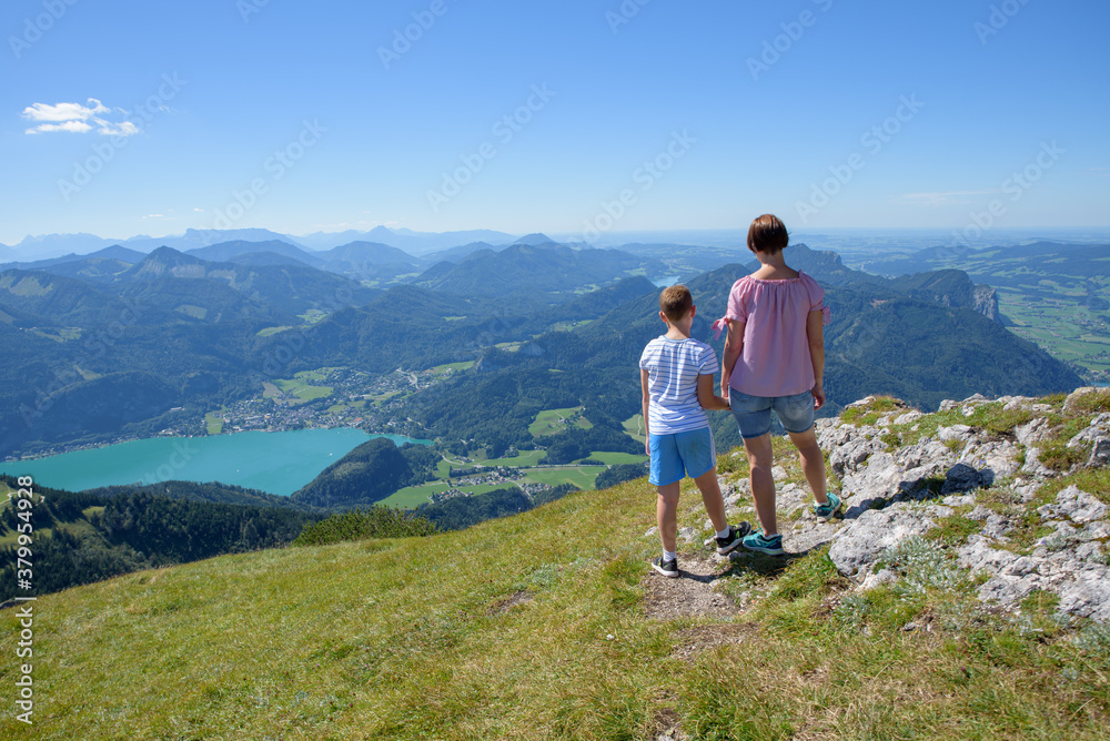Take a leisurely trip on this classic, olde worlde cog-railway up the Schafberg Mountain to a height of 1,783 metres. A Woman and son see the amazing view