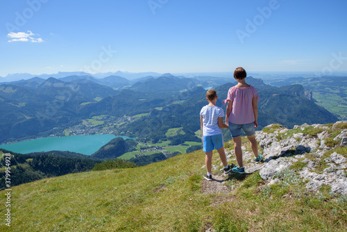 Take a leisurely trip on this classic, olde worlde cog-railway up the Schafberg Mountain to a height of 1,783 metres. A Woman and son see the amazing view photo