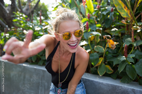 Beautiful blonde woman showing peace sign