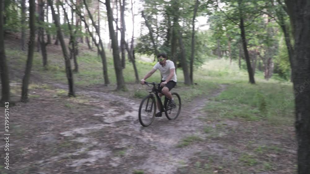 Young male cyclist asks help, calls 911, uses phone an ambulance mid-attack, chest pain, myocardial infarction, heart attack at young age athletes. Accident from sport training. Healthy and insurance. Young male cyclist asks help, calls 911, uses phone an ambulance mid-attack, chest pain, myocardial infarction, heart attack at young age athletes. Accident from sport training. Healthy and insurance.