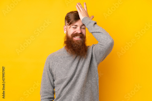 Redhead man with long beard over isolated yellow background has realized something and intending the solution