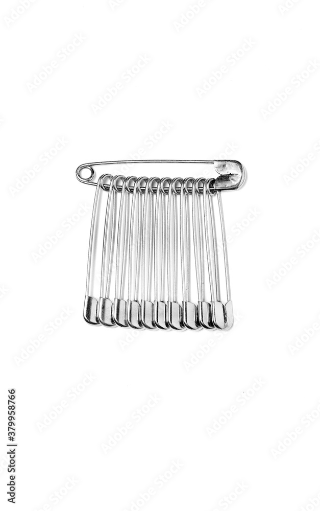 assembly of safety pins isolated on total white background