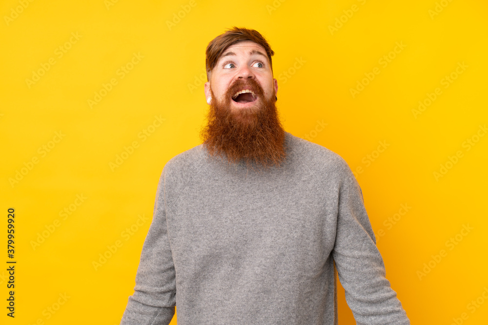 Redhead man with long beard over isolated yellow background smiling Redhead man with long beard over isolated yellow background smiling