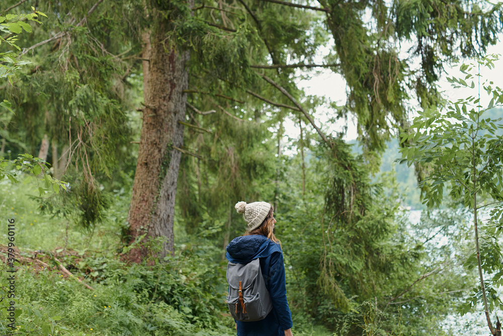 Adventure travel hiker woman in beautiful green forest on scenic Adventure travel hiker woman in beautiful green forest on scenic