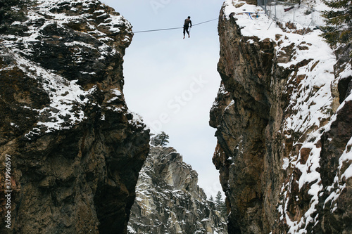 A adventurous man high lining across a highway