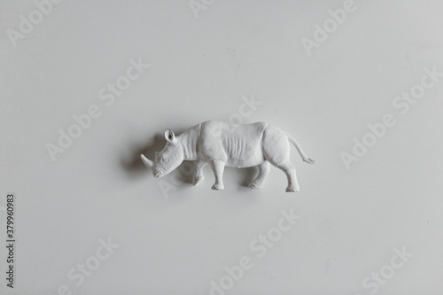 white rhino figurine on white table