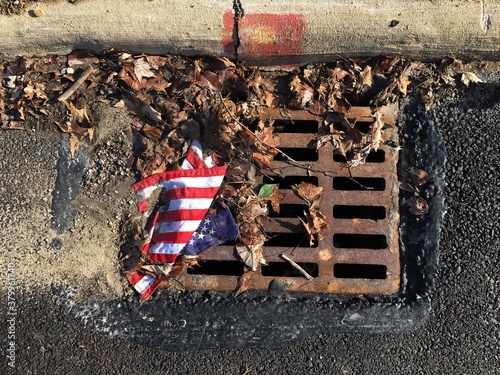 American flag in gutter photo