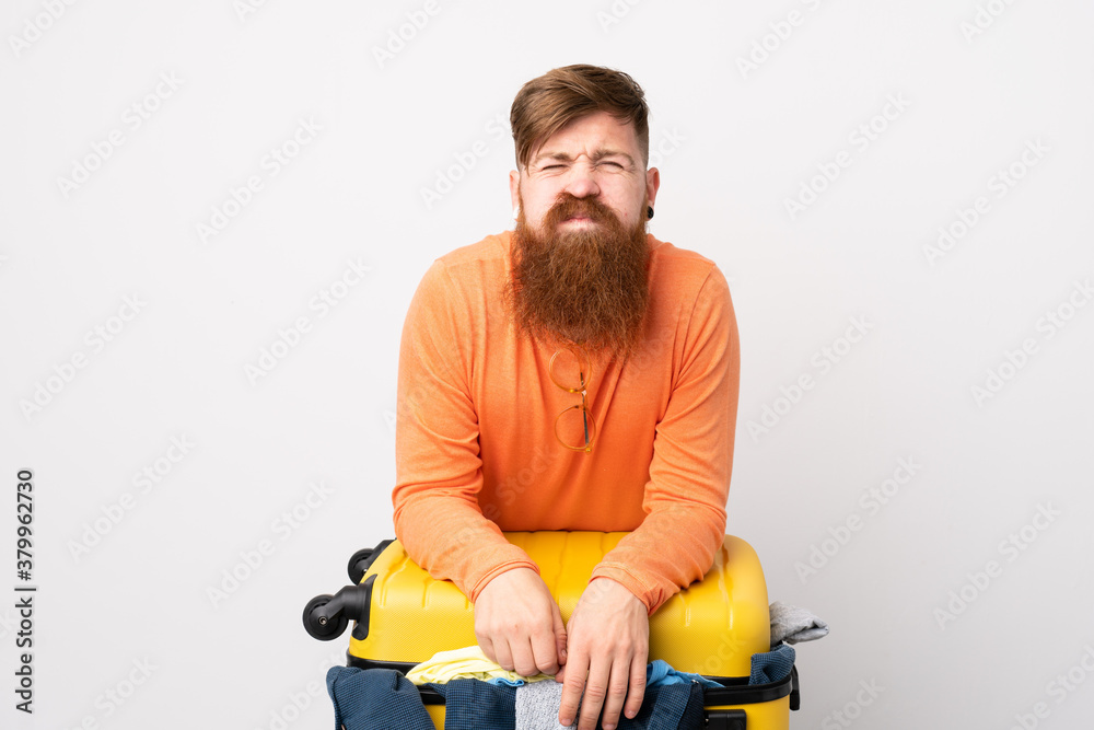 Traveler man with a suitcase full of clothes over isolated white background Traveler man with a suitcase full of clothes over isolated white background