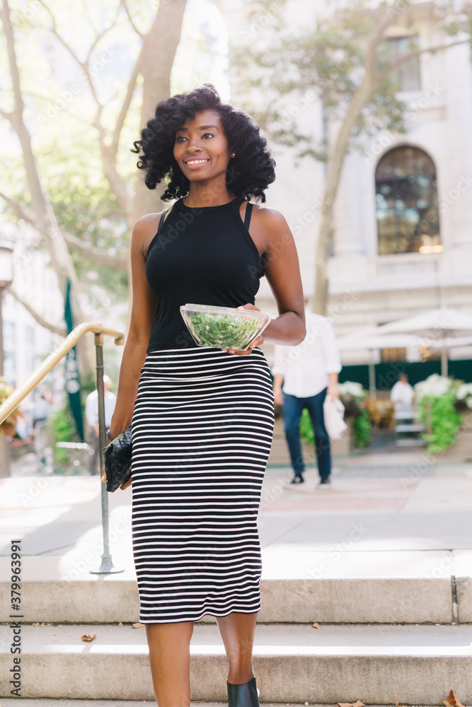Businesswoman at the park holding a fresh salad to go Businesswoman at the park holding a fresh salad to go
