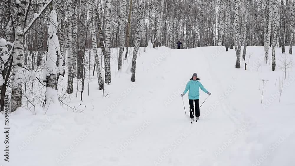 The girl is skiing down the mountain in winter, falls and laughs. Winter sports. Skiing. The girl is skiing down the mountain in winter, falls and laughs. Winter sports. Skiing.