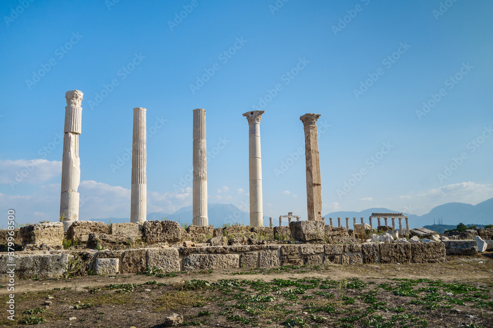 Corinthian columns on street of abandoned city Laodicea, Denizli, Turkey. Right column made of marble, also it's quadratic in section. All city is included in UNESCO Tentative Heritage List