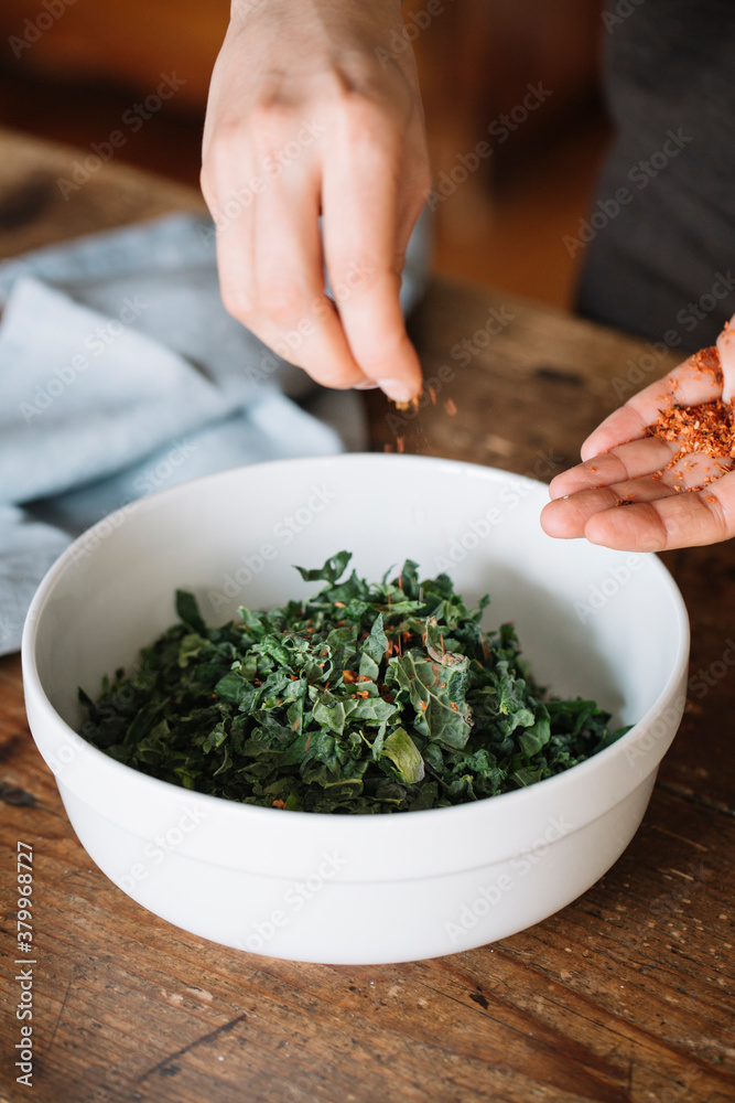 Chef spicing a salad