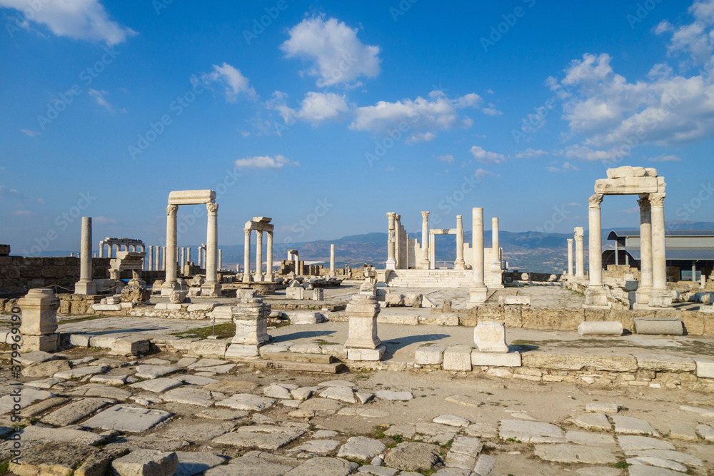 Panoramic view onto remains of buildings in Laodicea, ancient city near Denizli, Turkey. There are ruins of temple, colonnade & pieces of columns & walls. City included in Tentative List of UNESCO