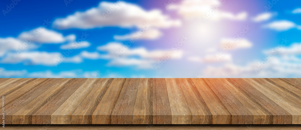 Empty wooden table in front of abstract blurred sky clouds background. can be used for display or montage your products