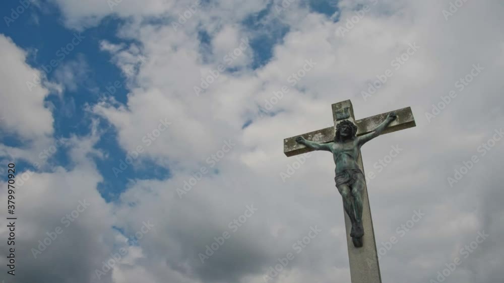 Jesus Christ on the cross against cloudy blue sky timelapse Jesus Christ on the cross against cloudy blue sky timelapse