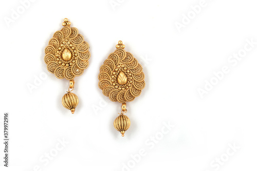 Beautiful Golden pair of earrings on white background. Luxury female jewelry, Indian traditional jewellery, kundan earrings,Bridal Gold earrings wedding jewellery