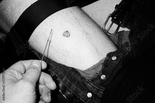 Stick and Poke Homemade tattoo on leg pizza slice photo