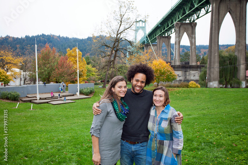 Man with two women in Cathedral Park in Portland, Oregon photo