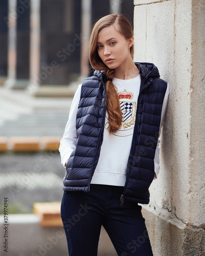Young beautiful blonde model in fashionable clothes on the street. Street modern womens fashion