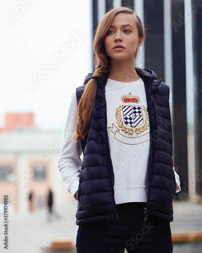 Young beautiful blonde model in fashionable clothes on the street. Street modern womens fashion